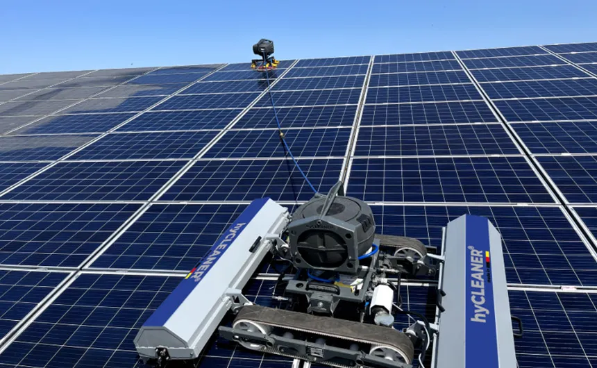 A robot cleaning a large solar panel array
